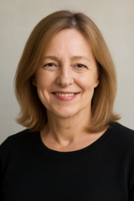 Woman with shoulder-length blonde hair wearing a black top against a neutral background